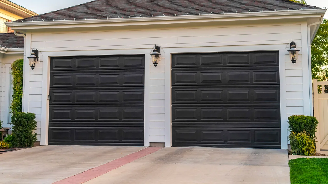 Two-car garage with dark carriage-style doors