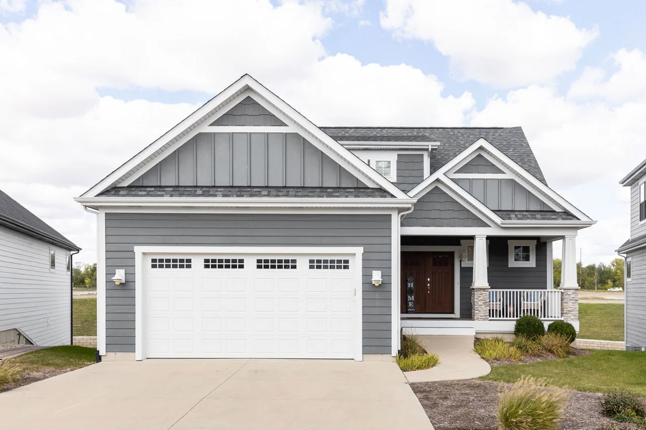 Gray craftsman home with attached two-car garage