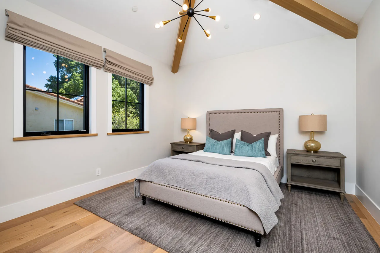Bedroom addition with vaulted ceiling and exposed wood beam