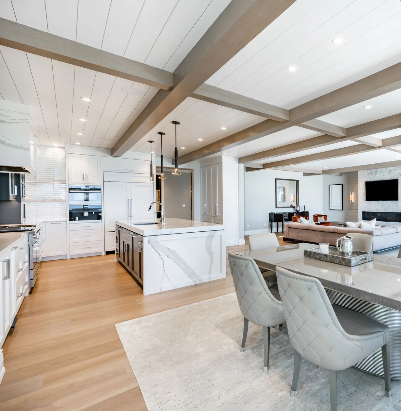 Whole-home renovation with open kitchen, beamed ceiling and dining area